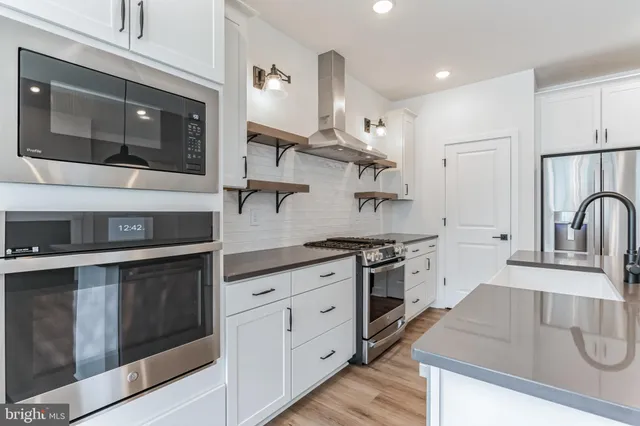 a kitchen with stainless steel appliances granite countertop a stove and a sink