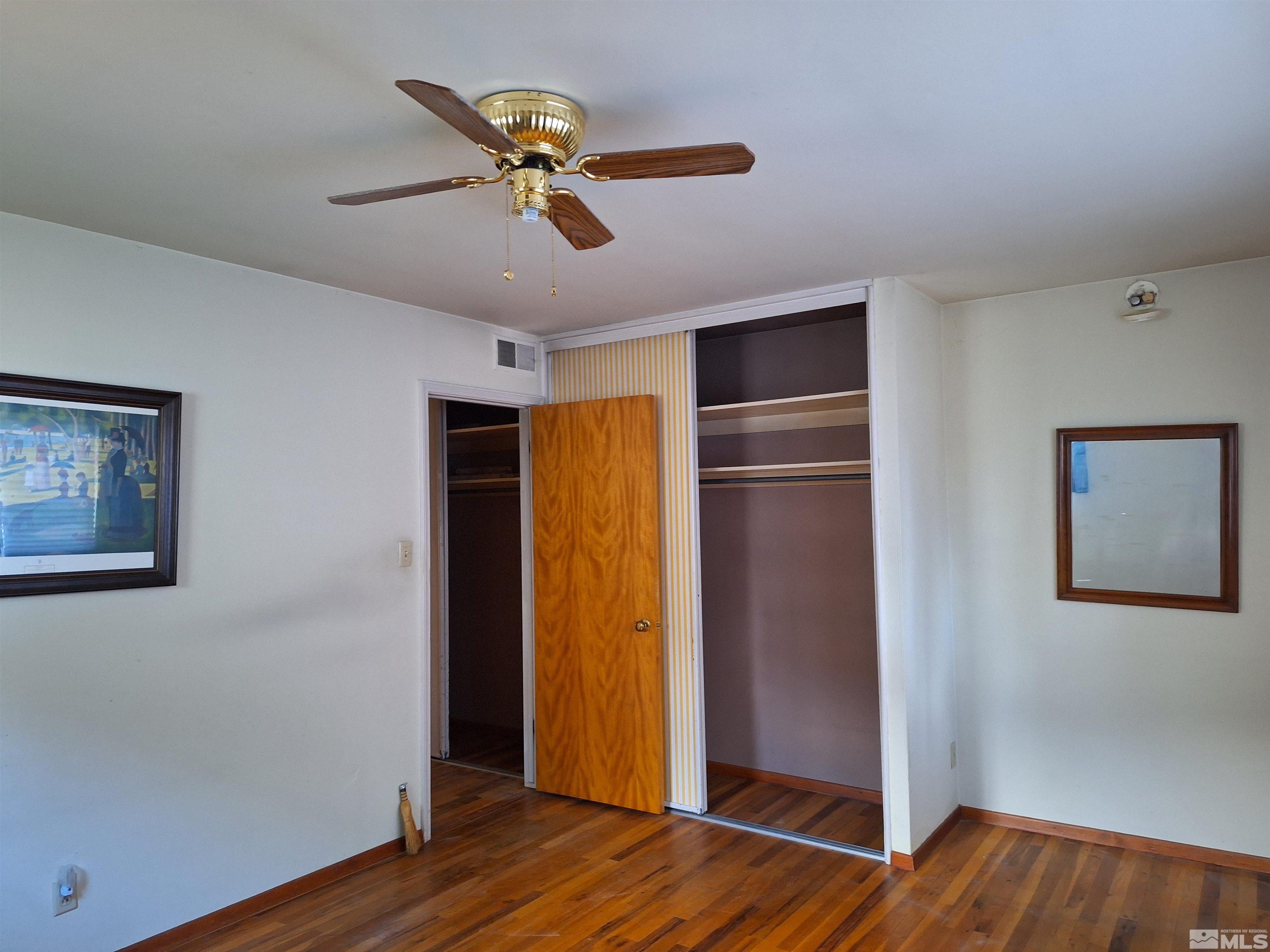 820 Ruby Avenue Reno, NV 89503 - Photo 21 of 30 a view of a livingroom with wooden floor and a ceiling fan