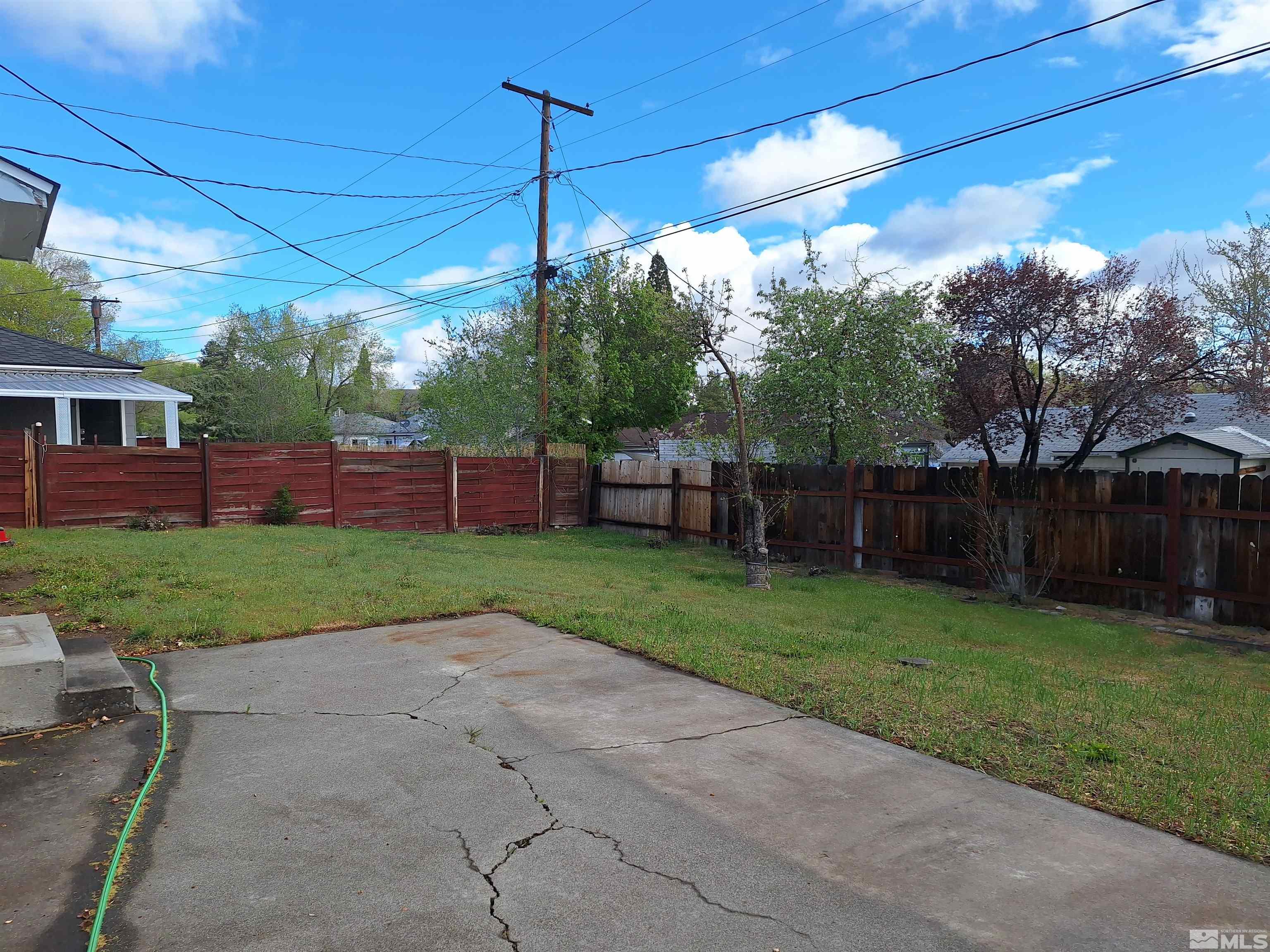 820 Ruby Avenue Reno, NV 89503 - Photo 30 of 30 a view of a backyard with table and chairs under an umbrella