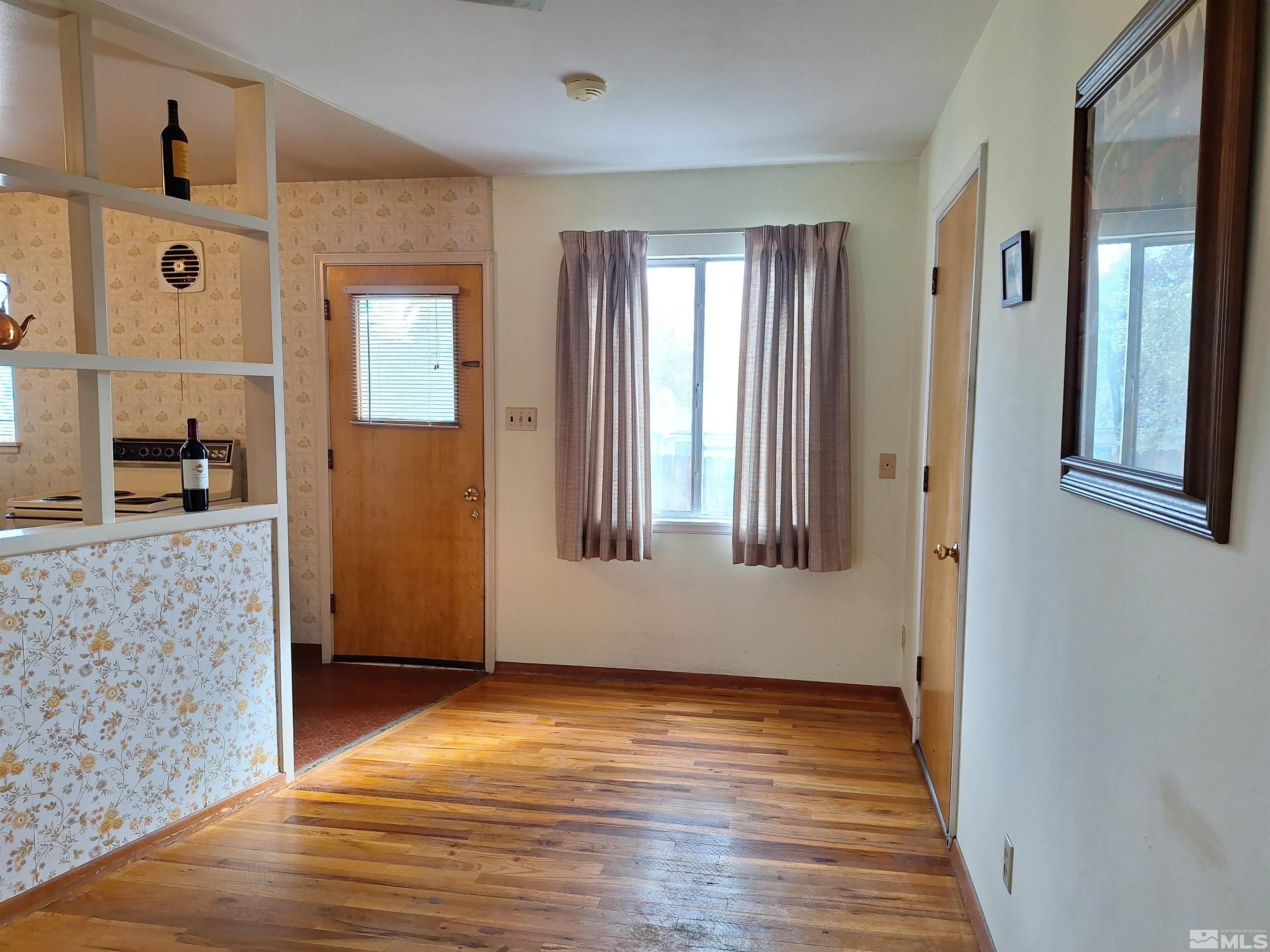 820 Ruby Avenue Reno, NV 89503 - Photo 8 of 30 a view of an empty room with wooden floor and a window