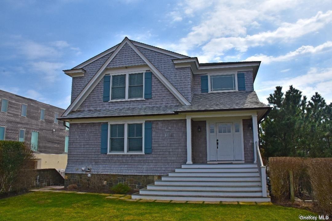 493 Dune Road Westhampton Beach, NY 11978 - Photo 8 of 11 a front view of a house with a yard