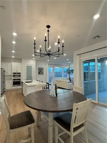 a dining room with furniture and wooden floor