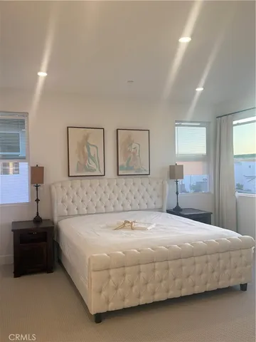 a bedroom with a bed and a couch