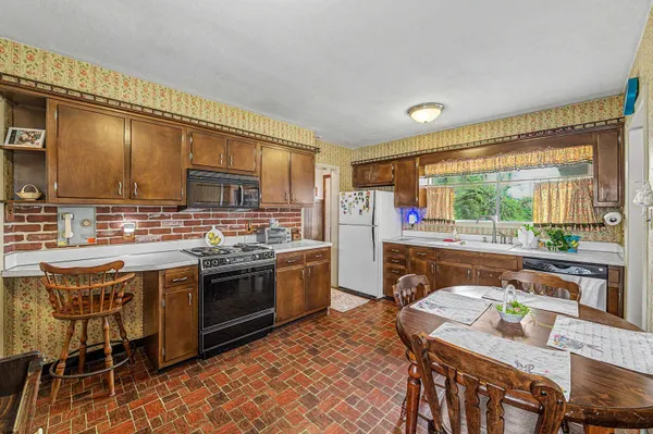 a kitchen with a table and chairs in it