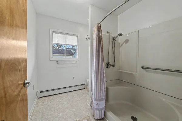 a bathroom with a toilet and a shower