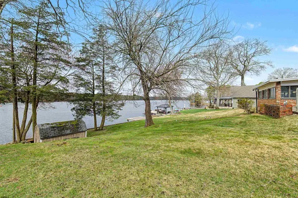 a view of a big yard with wooden fence