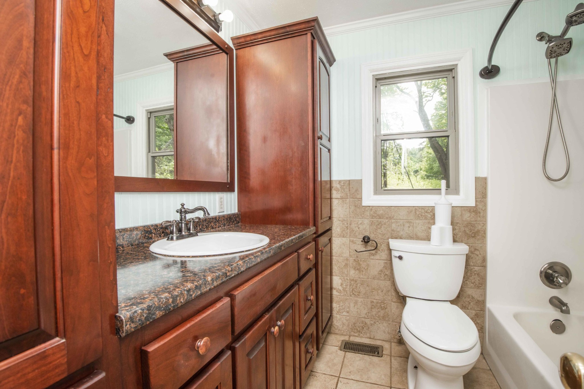 1455 Kiser Road Philadelphia, TN 37846 - Photo 16 of 40 a bathroom with a granite countertop sink toilet mirror vanity and shower