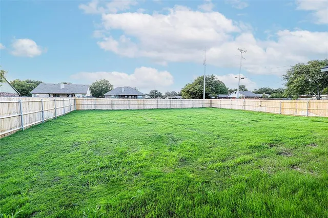 a front view of a house with a garden and yard