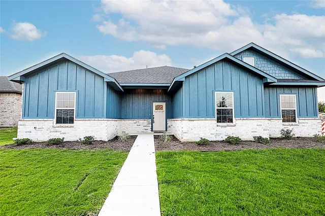 a view of a house with a yard and porch