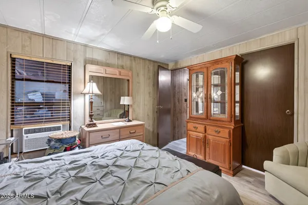 a bedroom with a bed and wooden floor