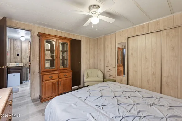 a bedroom with a large bed and a chandelier