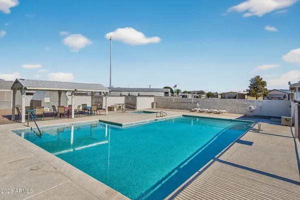a view of a swimming pool and lounge chairs