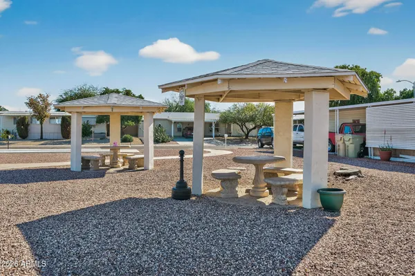 a view of a patio with a table and chairs under an umbrella