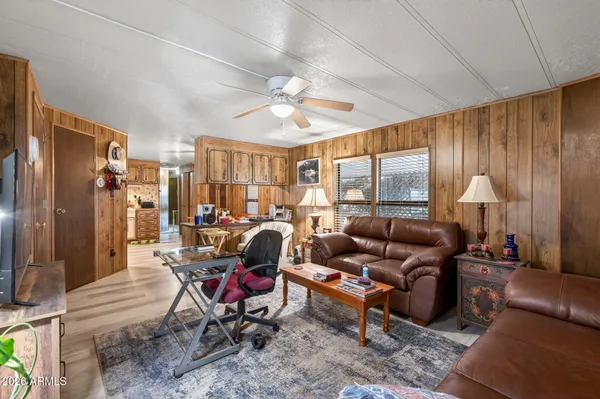 a living room with furniture a chandelier and a rug