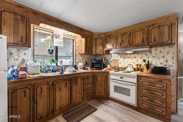 a kitchen with stainless steel appliances granite countertop a stove and cabinets