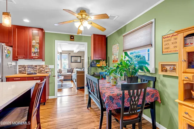 a dining room with furniture a window and wooden floor