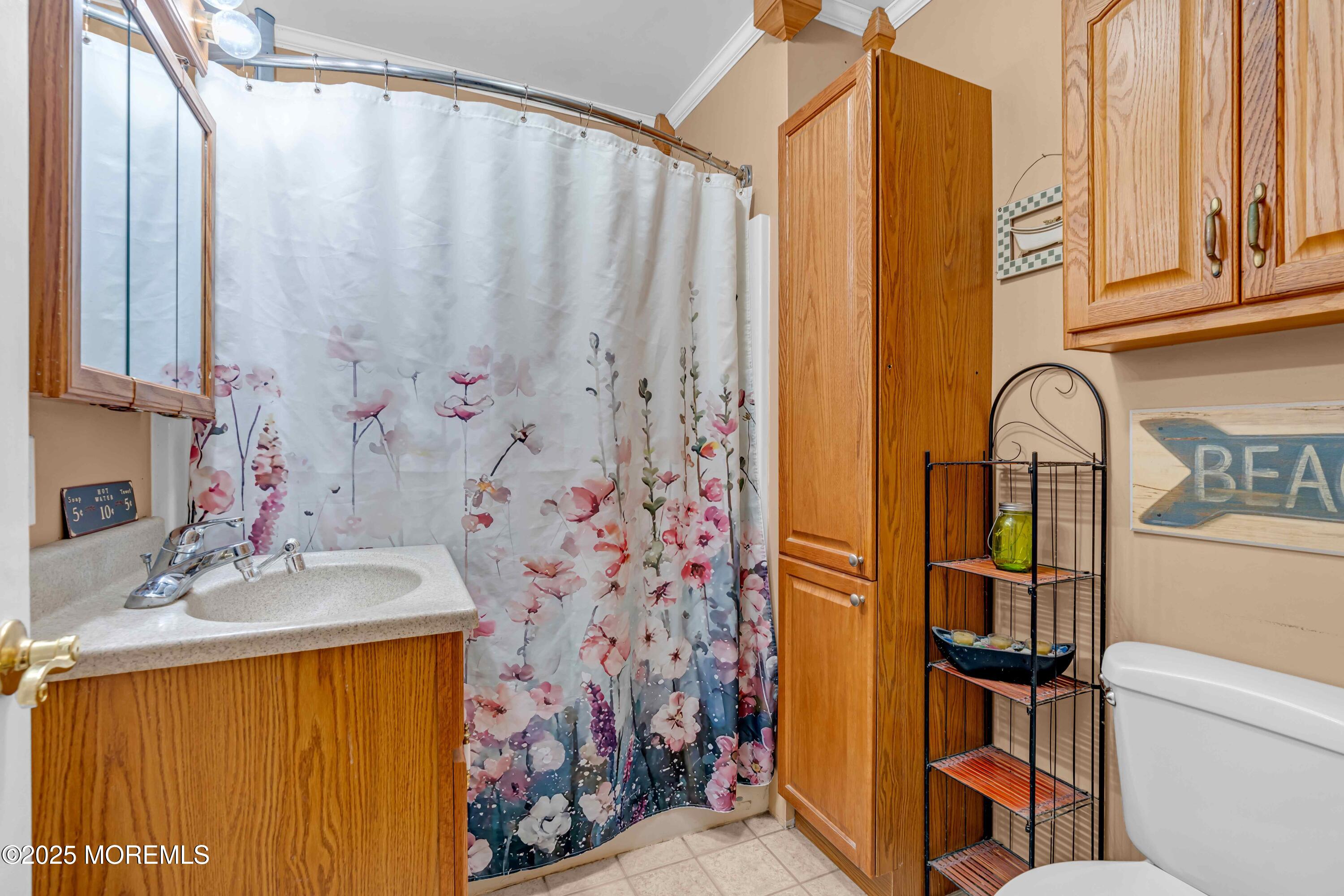 64 Roland Street Keansburg, NJ 07734 - Photo 21 of 38 a bathroom with a sink and a mirror