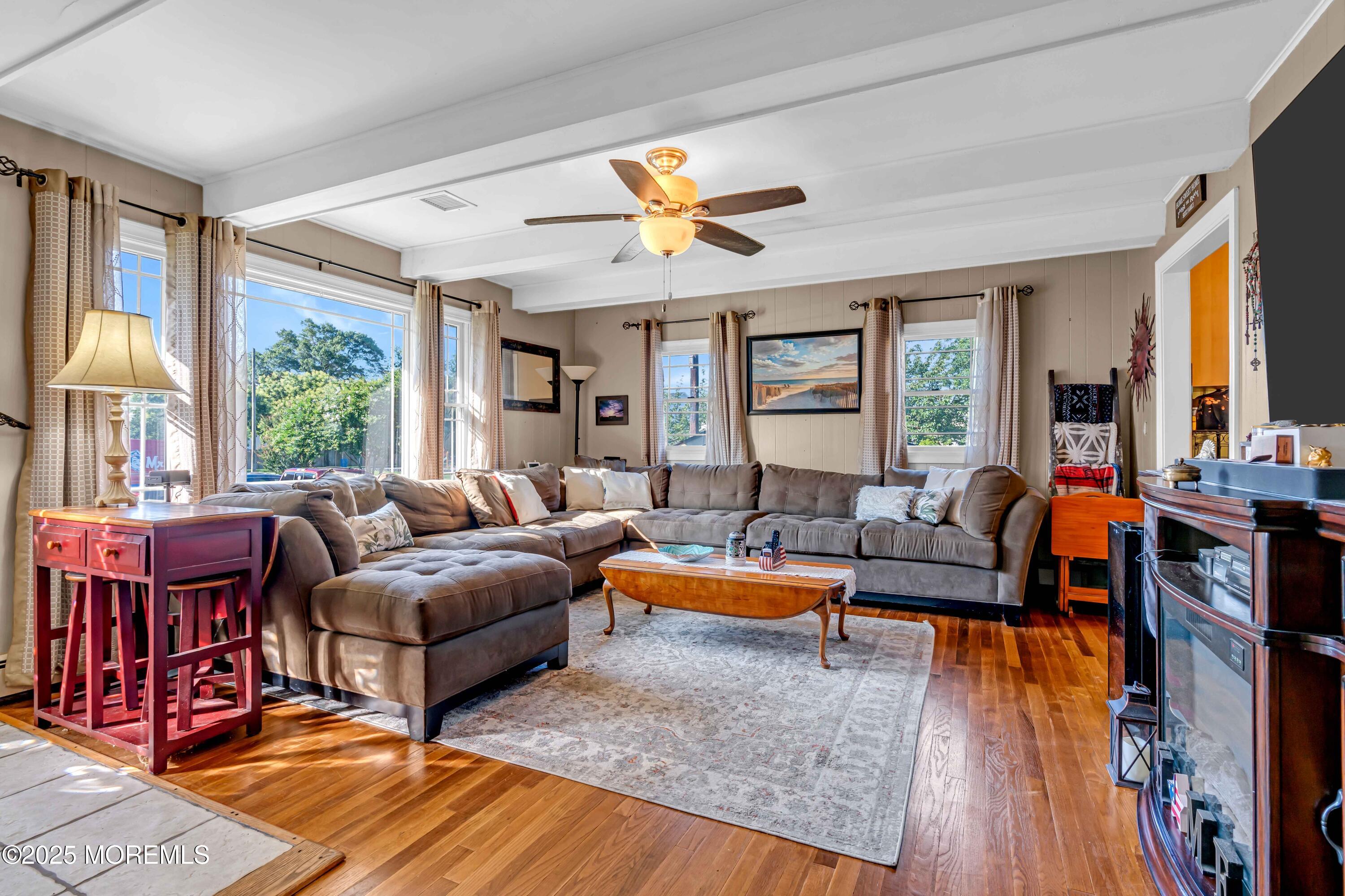 64 Roland Street Keansburg, NJ 07734 - Photo 3 of 38 a living room with furniture fireplace and a large window