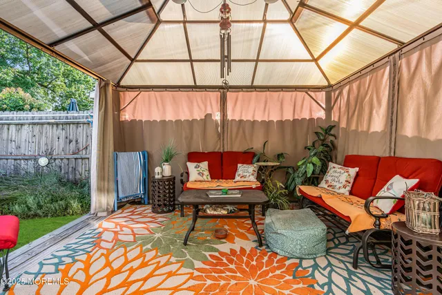 a outdoor sitting area with furniture and wooden floor