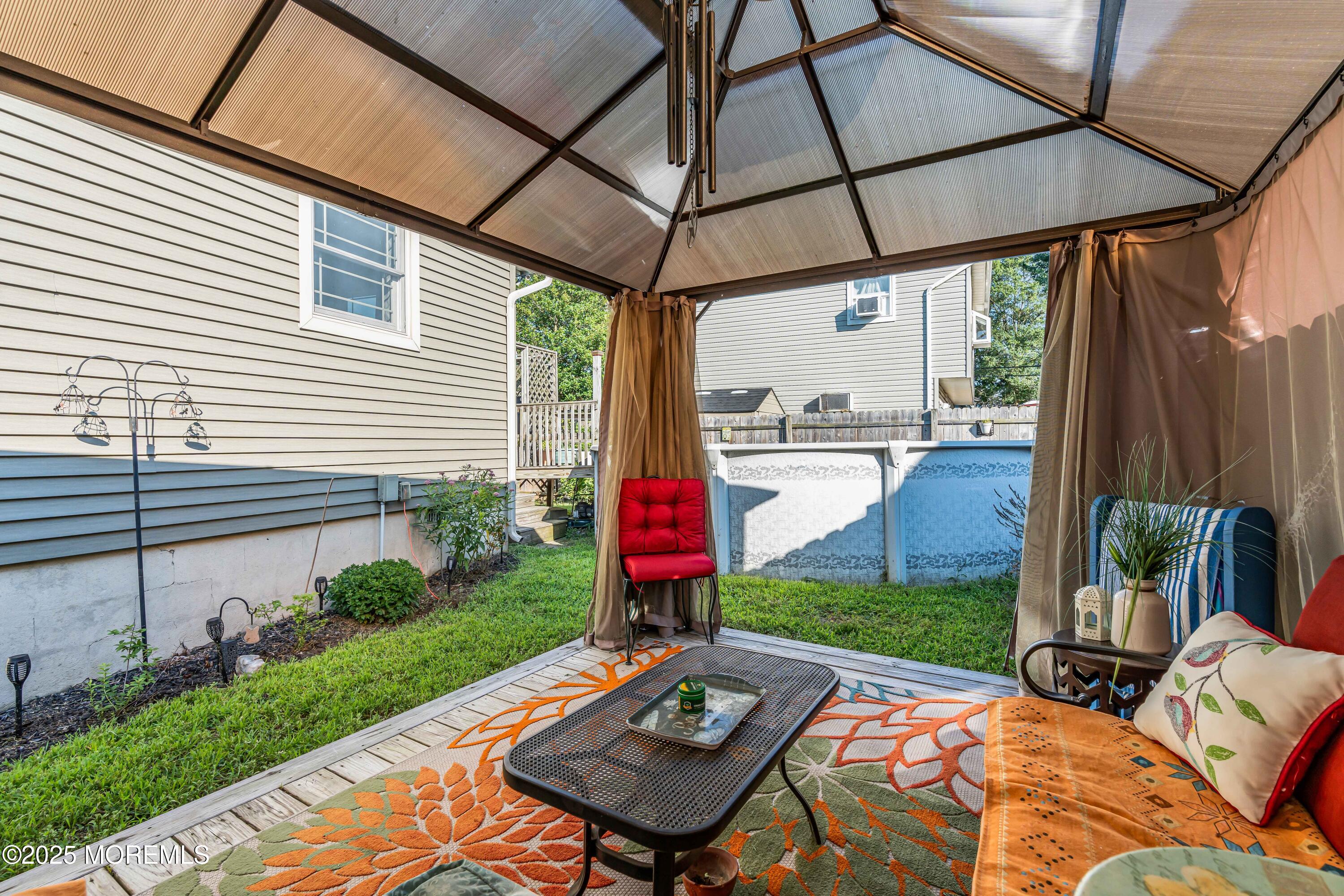 64 Roland Street Keansburg, NJ 07734 - Photo 32 of 38 a view of a backyard with a patio table and chairs