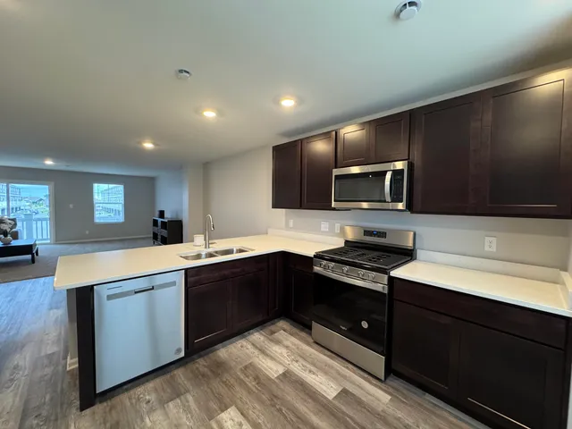 a view of kitchen with refrigerator and window