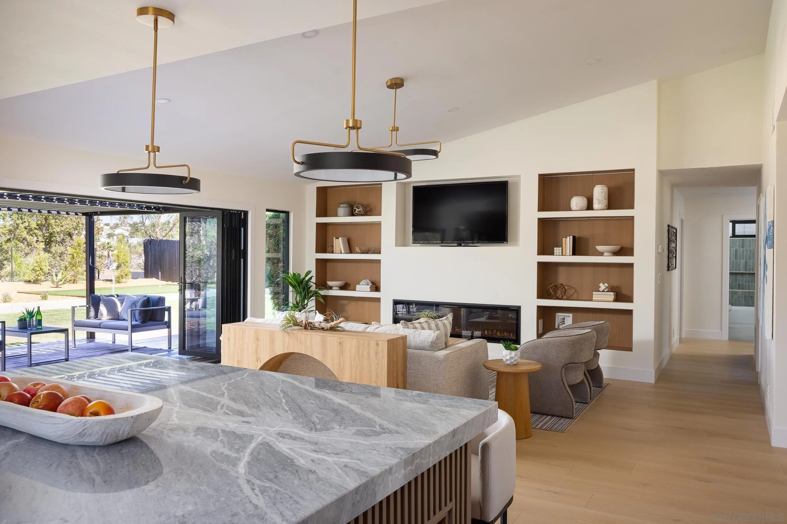 1502 Vanessa Circle Encinitas, CA 92024 - Photo 11 of 40 a living room with stainless steel appliances kitchen island granite countertop a table chairs and a living room