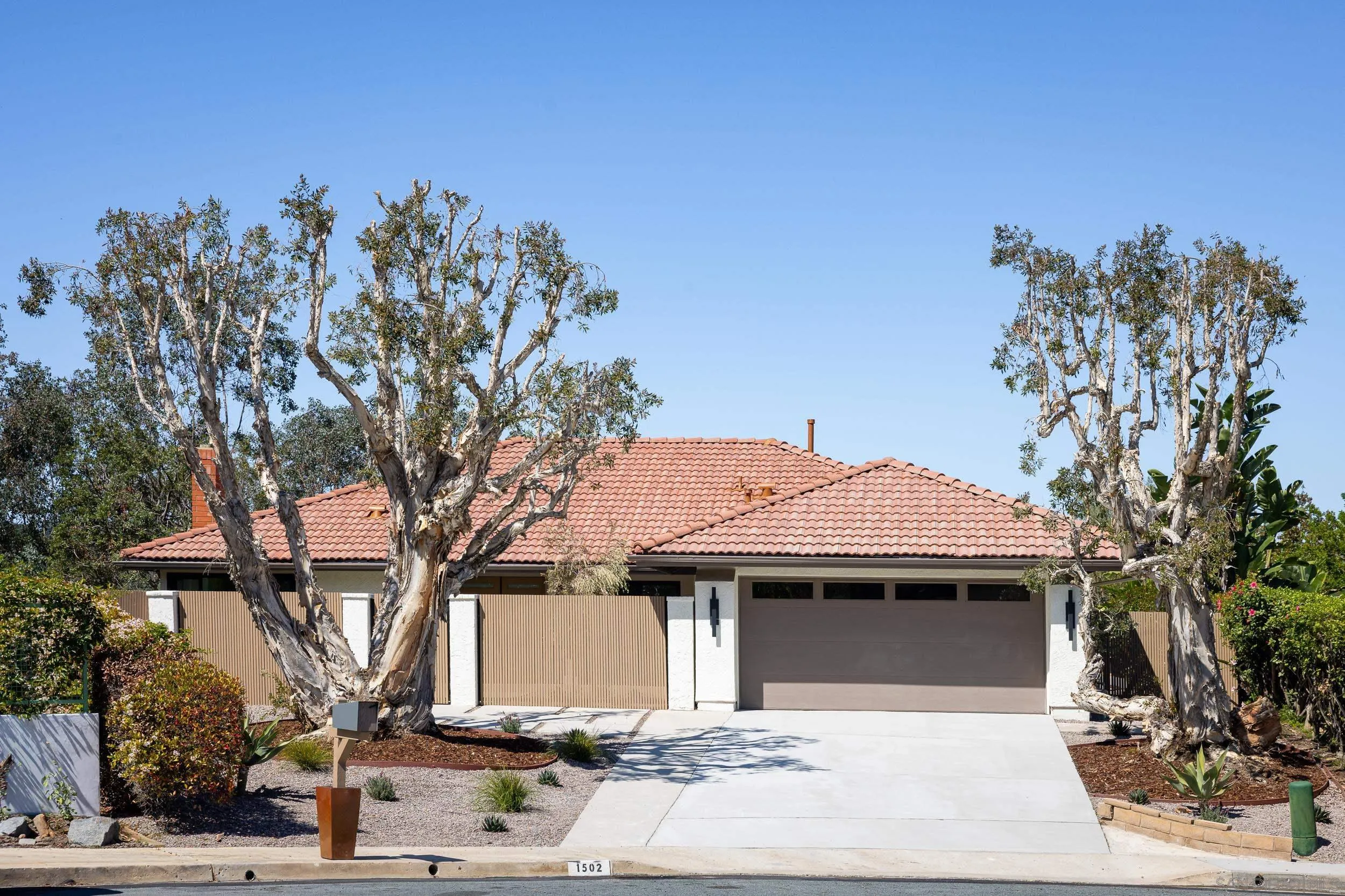 1502 Vanessa Circle Encinitas, CA 92024 - Photo 2 of 40 a front view of a house with a tree