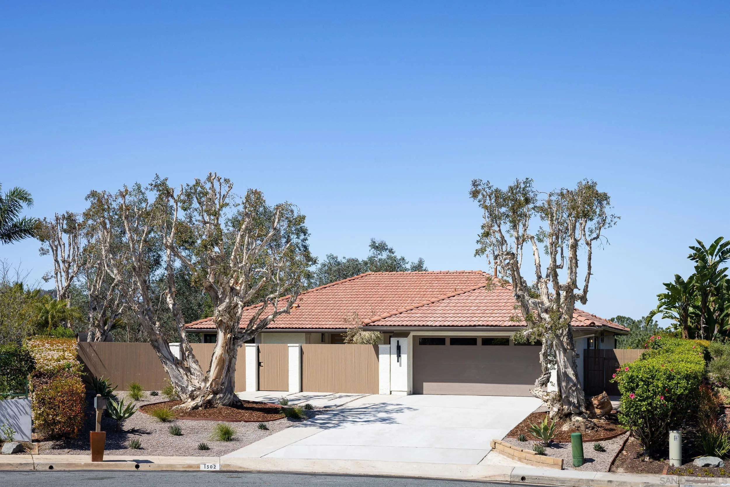 1502 Vanessa Circle Encinitas, CA 92024 - Photo 3 of 40 a front view of a house with a tree