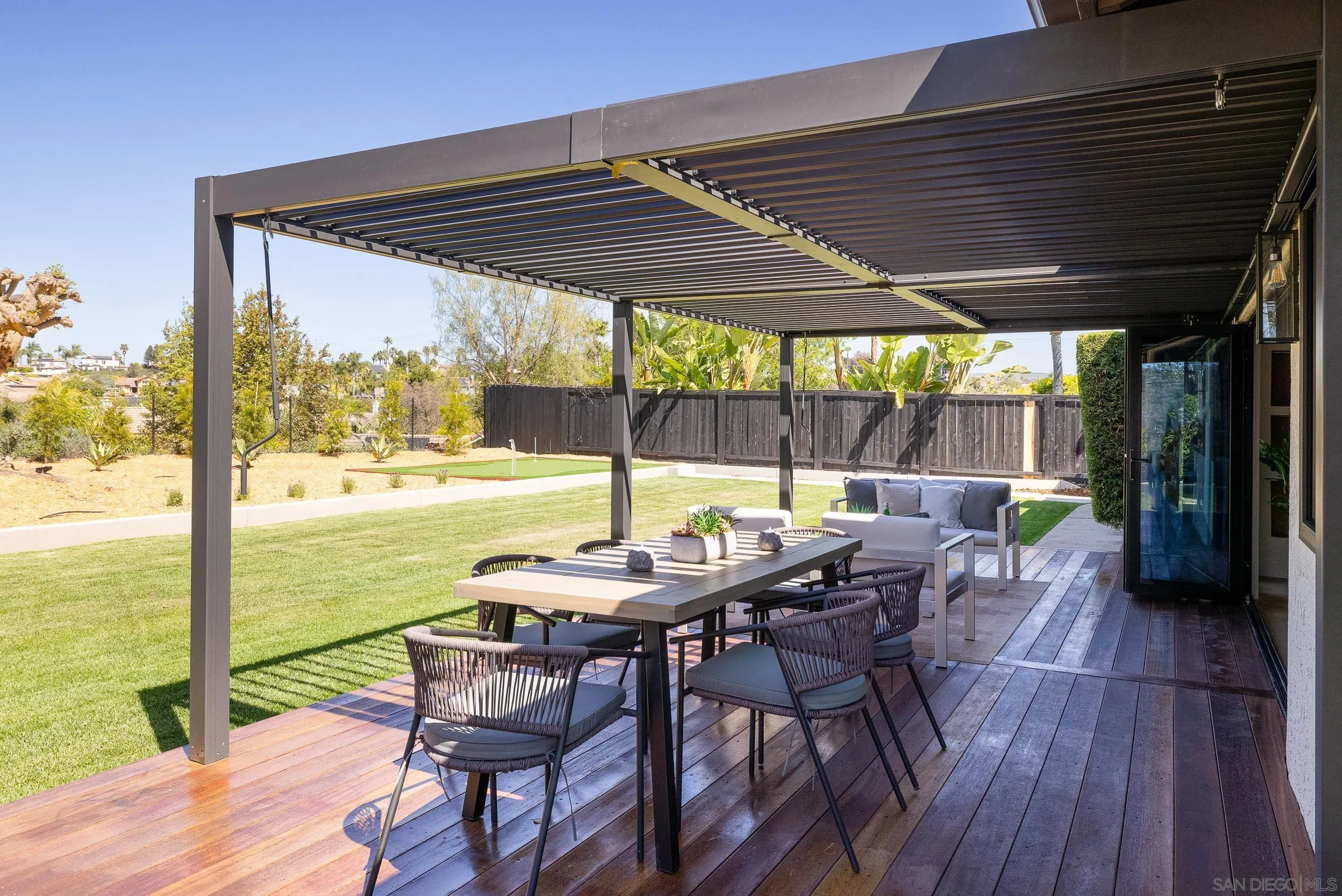 1502 Vanessa Circle Encinitas, CA 92024 - Photo 31 of 40 a patio with wooden floor a yard tables and chairs