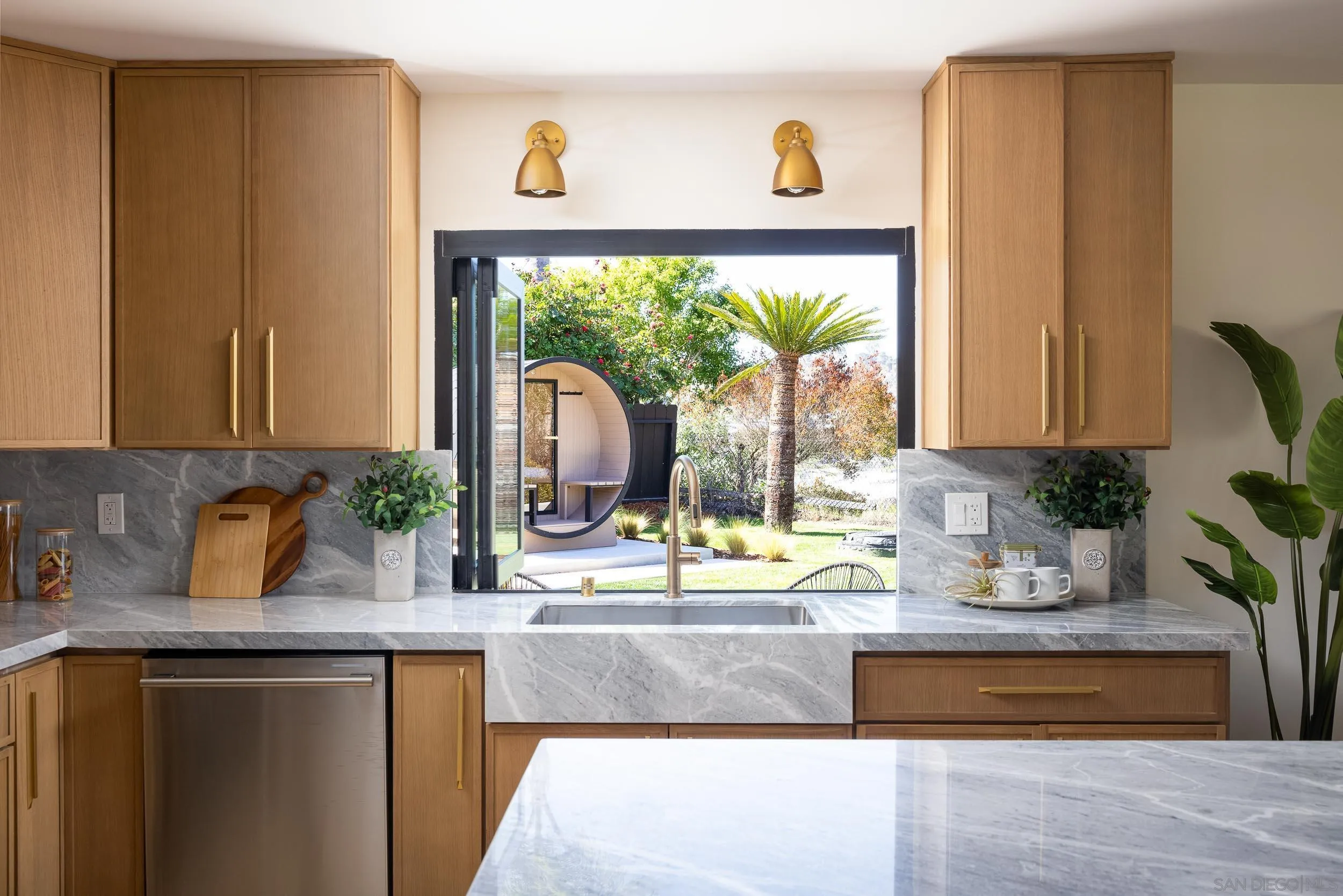1502 Vanessa Circle Encinitas, CA 92024 - Photo 10 of 40 a kitchen with a granite countertop sink and a large window