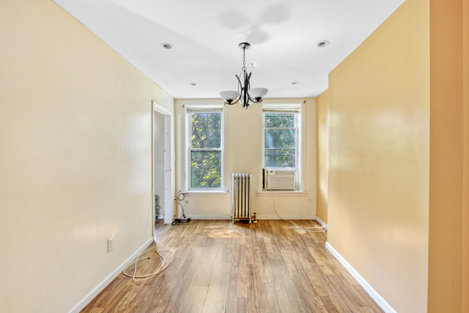 614 St Johns Place Brooklyn, NY 11238 - Photo 12 of 34 a view of empty room with wooden floor and fan