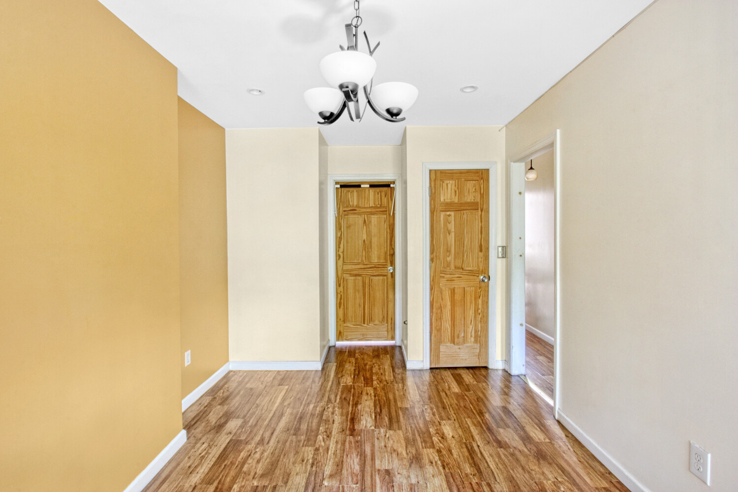 614 St Johns Place Brooklyn, NY 11238 - Photo 13 of 34 a view of hallway with wooden floor and chandelier