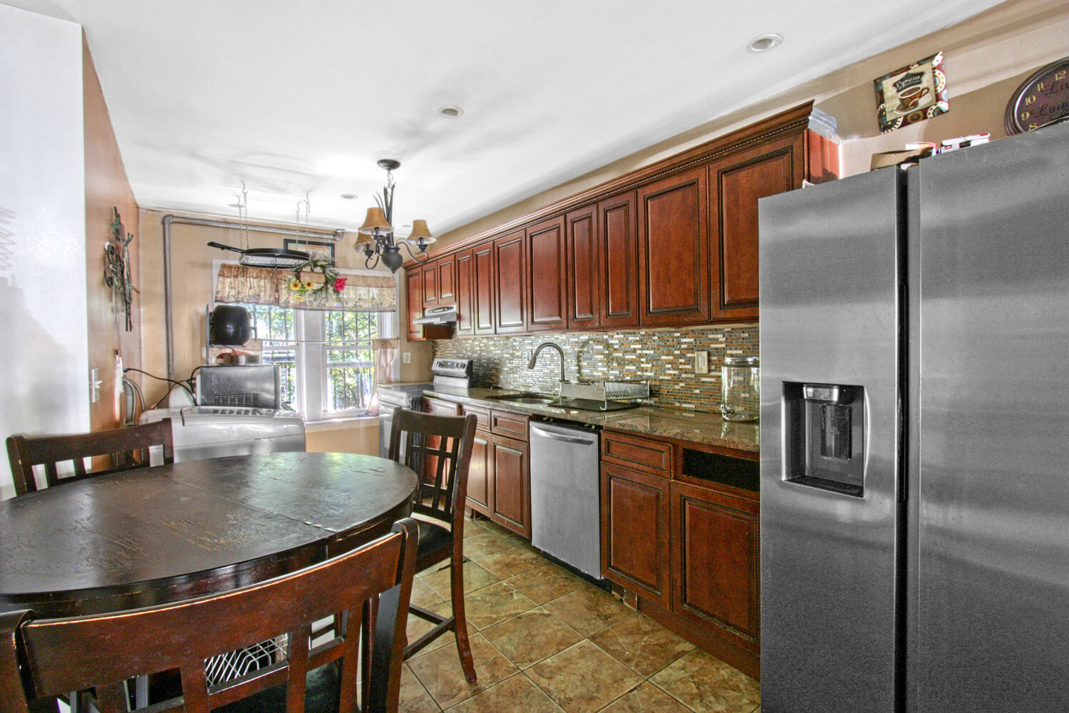 614 St Johns Place Brooklyn, NY 11238 - Photo 20 of 34 a kitchen with stainless steel appliances granite countertop a sink refrigerator and microwave