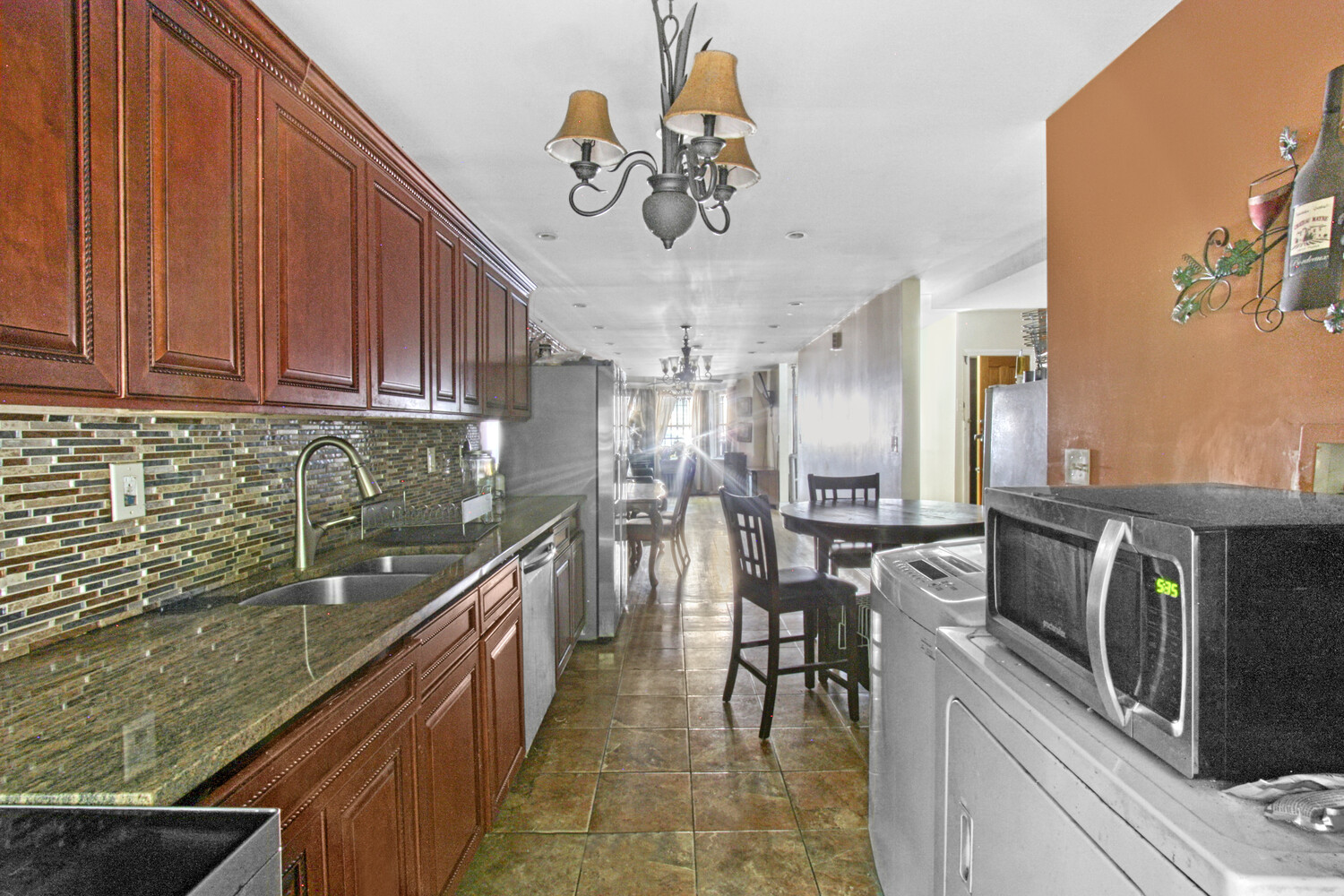 614 St Johns Place Brooklyn, NY 11238 - Photo 21 of 34 a kitchen with stainless steel appliances granite countertop a sink dishwasher a stove a oven with a dining table and chairs