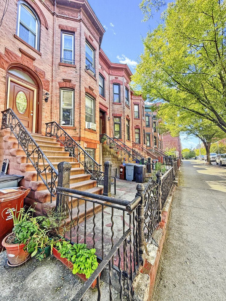 614 St Johns Place Brooklyn, NY 11238 - Photo 32 of 34 a city street lined with buildings and trees