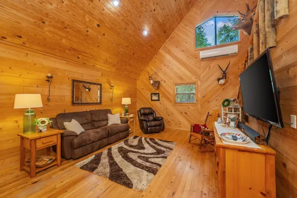 a spacious bedroom with a bed and wooden floor
