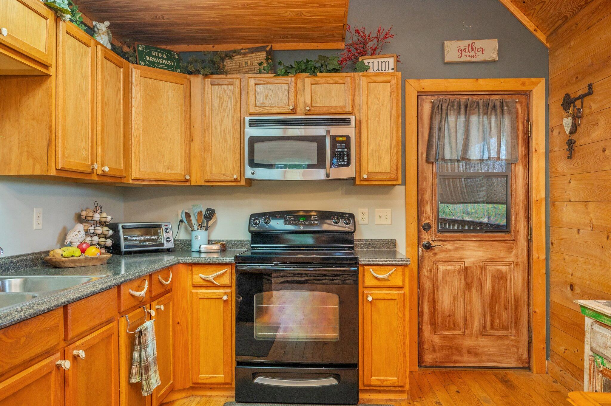 8109 Highway 189 Baker, FL 32531 - Photo 18 of 95 a kitchen with stainless steel appliances granite countertop a stove a sink and a microwave