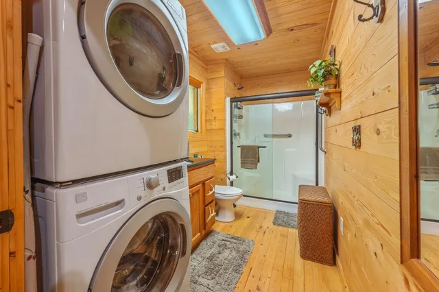 a view of a dining room with furniture floor to ceiling window and wooden floor