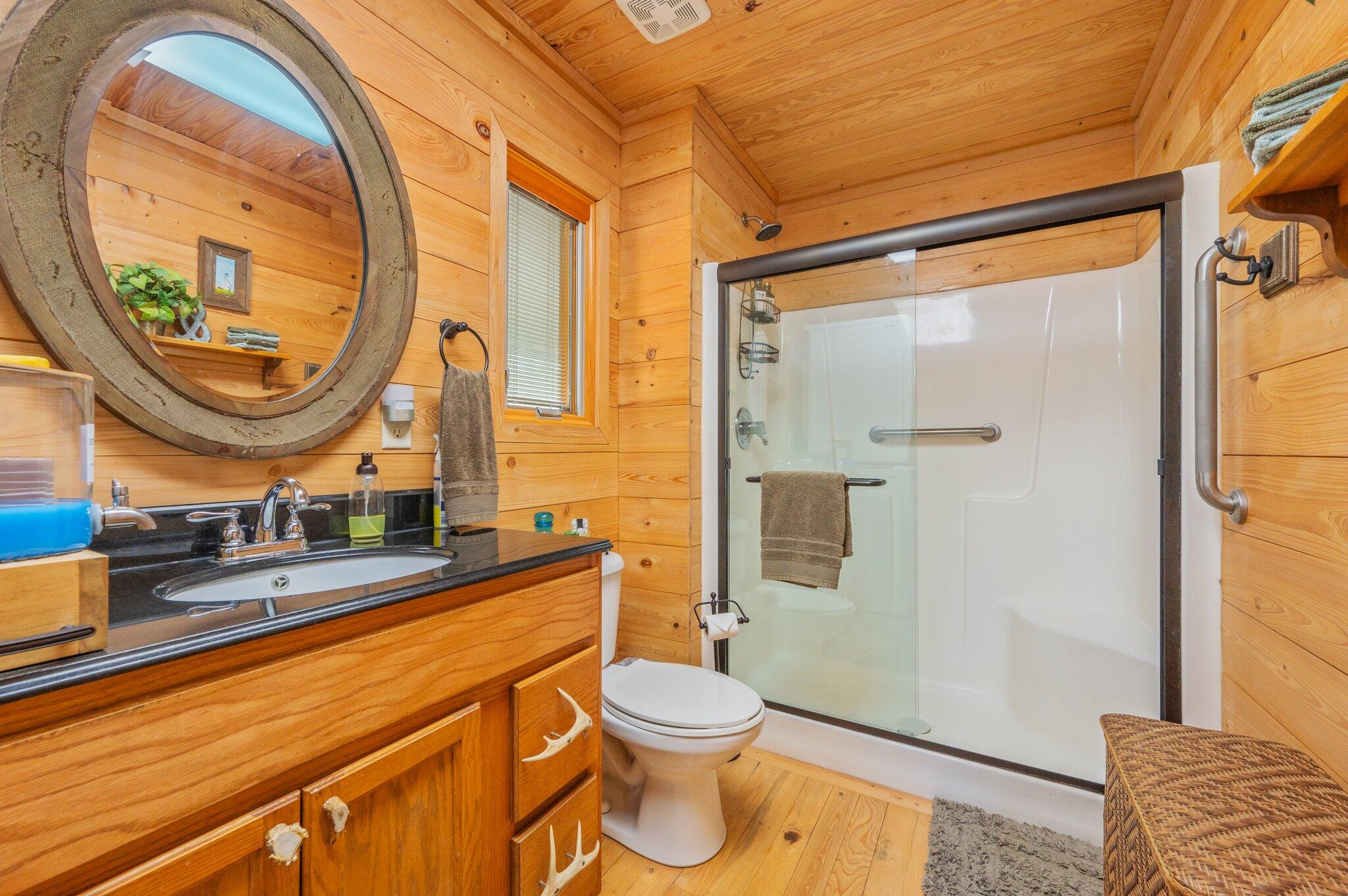 8109 Highway 189 Baker, FL 32531 - Photo 25 of 95 a bathroom with a granite countertop toilet a sink and a mirror