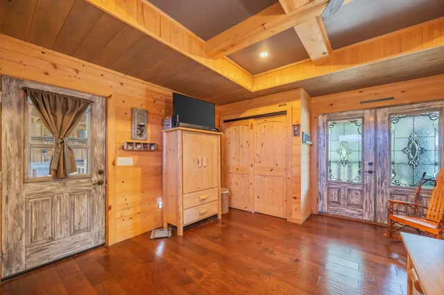 a front view of a house with a yard and trees