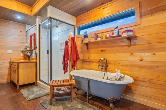 a view of a house with a yard and a large tree