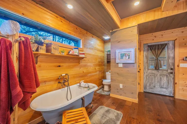 a kitchen with granite countertop cabinets stainless steel appliances a sink and a window