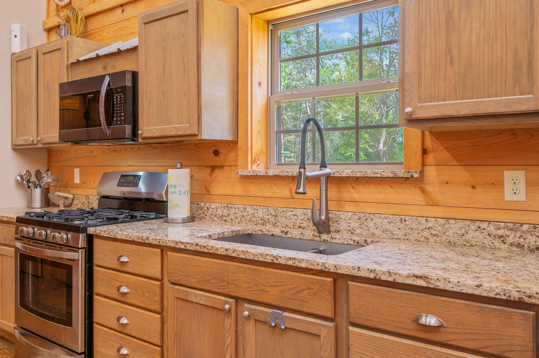 8109 Highway 189 Baker, FL 32531 - Photo 61 of 95 a kitchen with granite countertop cabinets stainless steel appliances a sink and a window