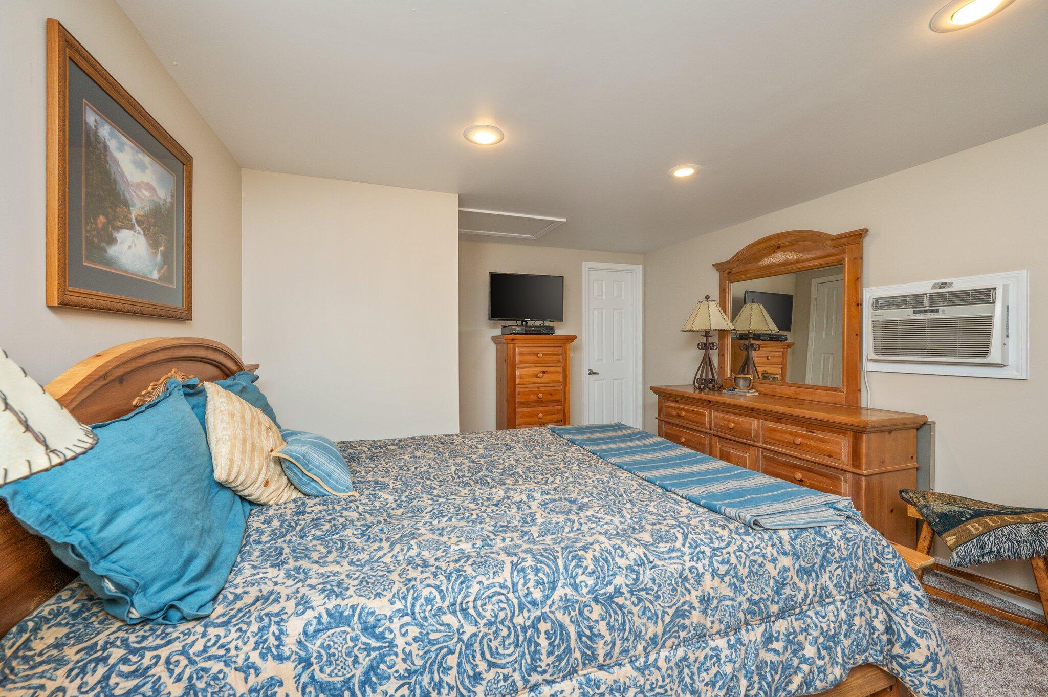 8109 Highway 189 Baker, FL 32531 - Photo 71 of 95 a bedroom with a bed and dresser with mirror