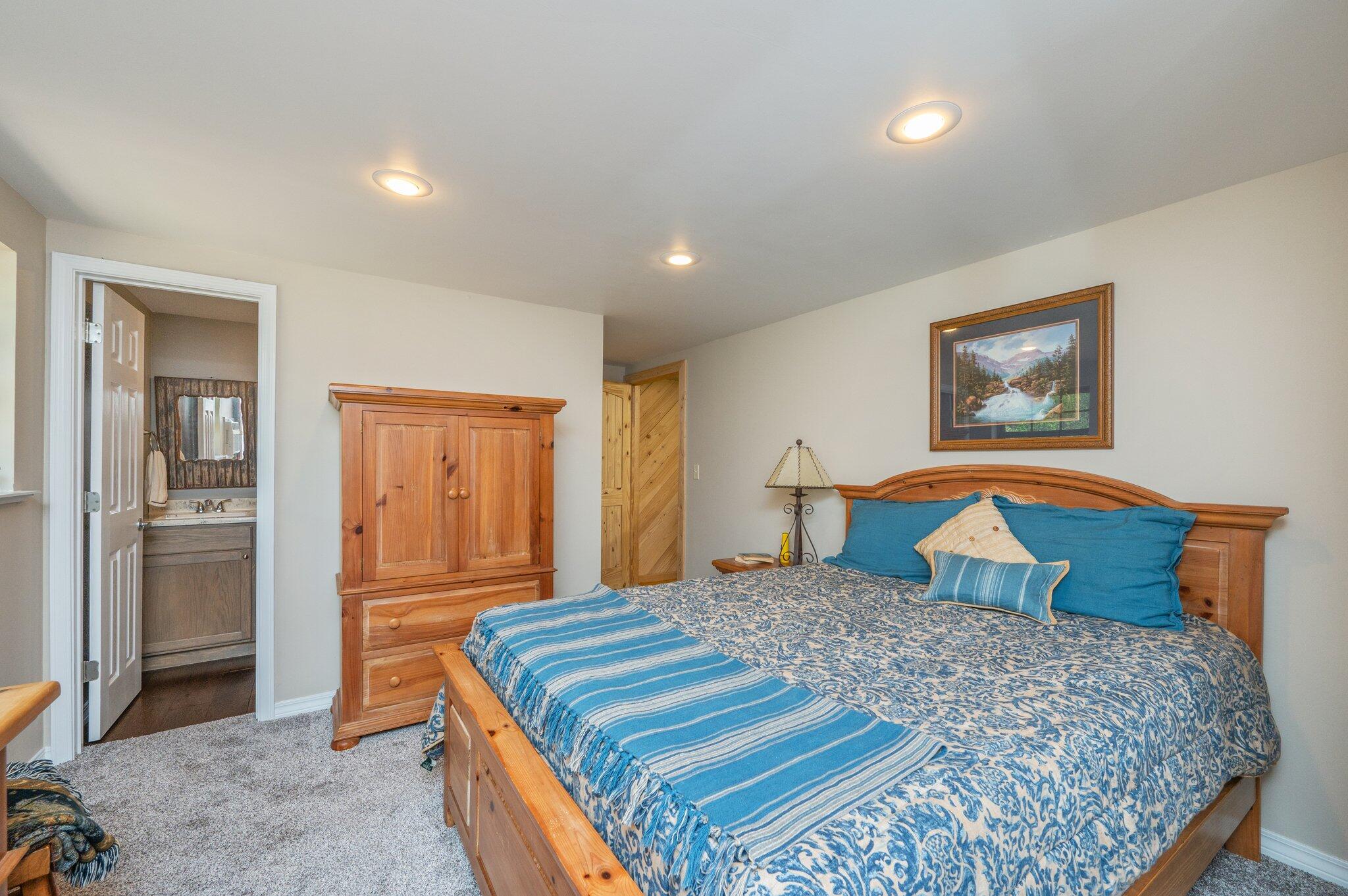 8109 Highway 189 Baker, FL 32531 - Photo 73 of 95 a bedroom with a large bed and a chandelier