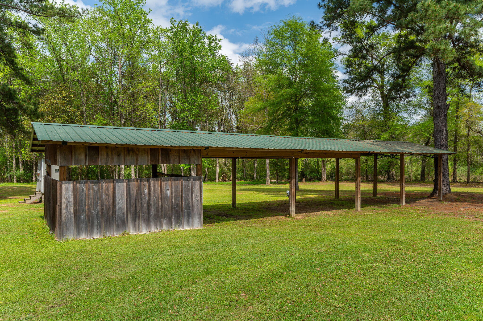 8109 Highway 189 Baker, FL 32531 - Photo 76 of 95 a backyard of a house with lawn chairs plants and large tree
