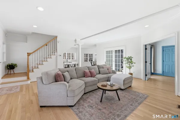 a living room with furniture and a wooden floor