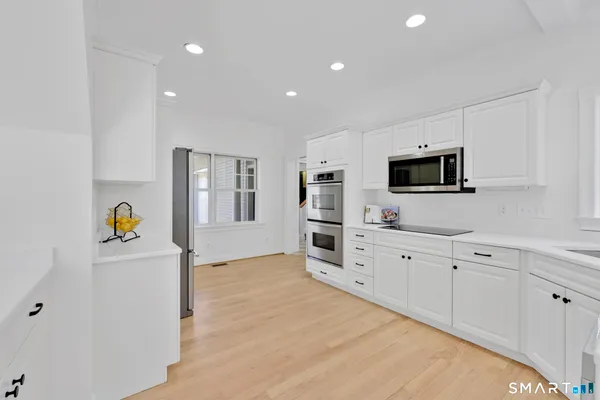 a kitchen with a sink a table and chairs