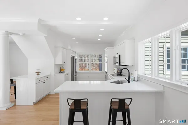 a kitchen with stainless steel appliances a refrigerator sink and cabinets