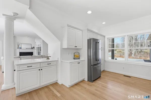 a kitchen with granite countertop a white cabinets and window